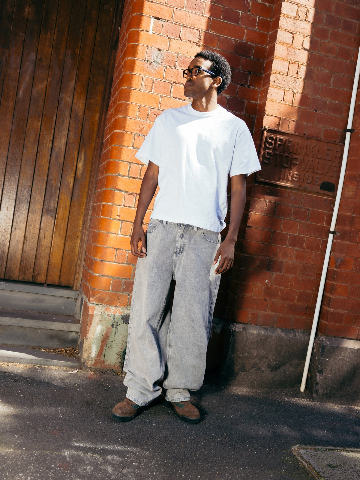Butter Goods Wide Cut Denim Jeans Grey Wash — worn by model