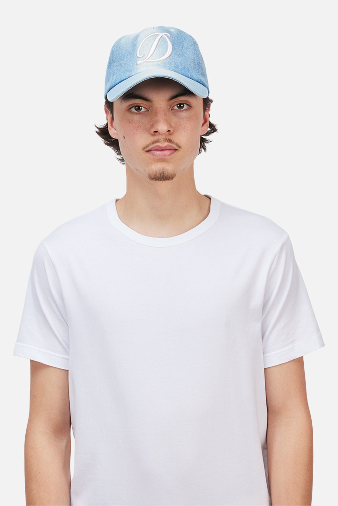Model wearing the Dime MTL Cursive Denim Worker Cap in Blue Washed