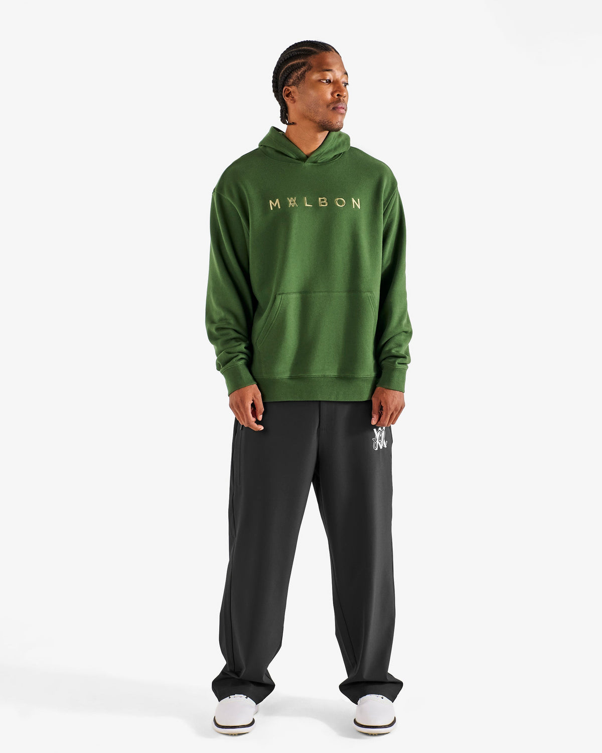 Malbon Golf x Daniel Arsham Shards Hoodie – Olive Stealth Camo worn on model — olive camo pullover hoodie with Arsham shards graphic, Gallery Streetwear Canada