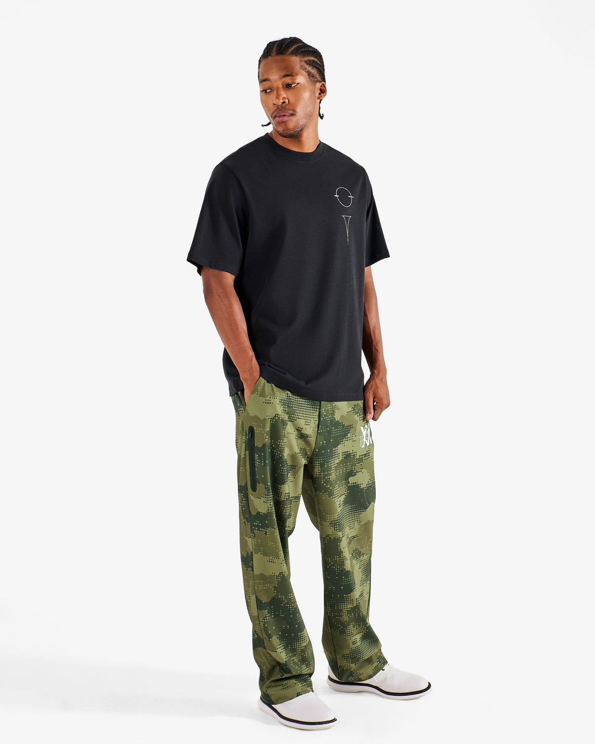 Malbon Golf x Daniel Arsham Bermuda Glyph Tee – Black worn on model — black cotton tee with Arsham glyph graphic, Gallery Streetwear Canada
