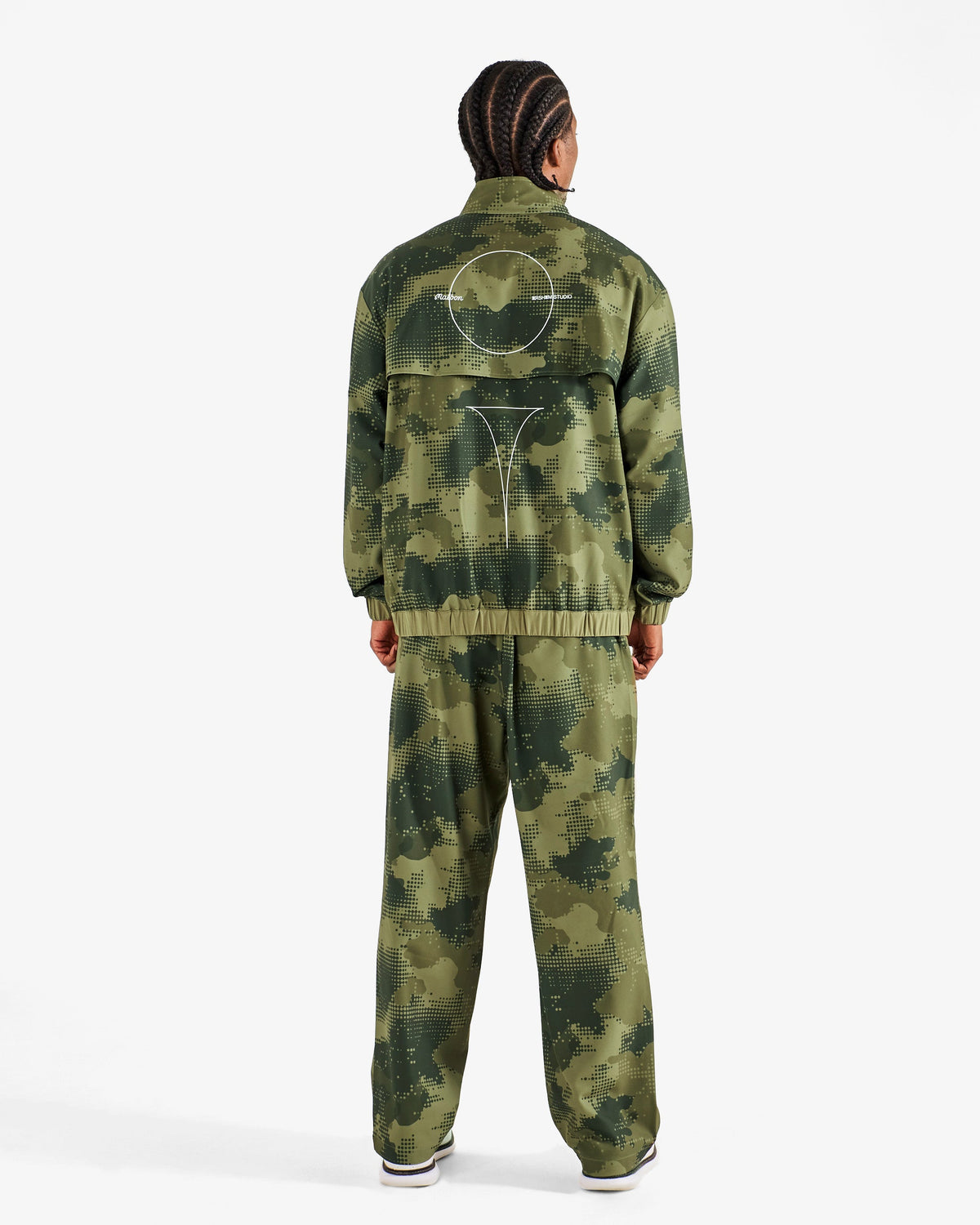 Malbon Golf x Daniel Arsham Stealth Quarter Zip – Olive Stealth Camo worn on model — olive camo quarter-zip golf midlayer, Gallery Streetwear Canada