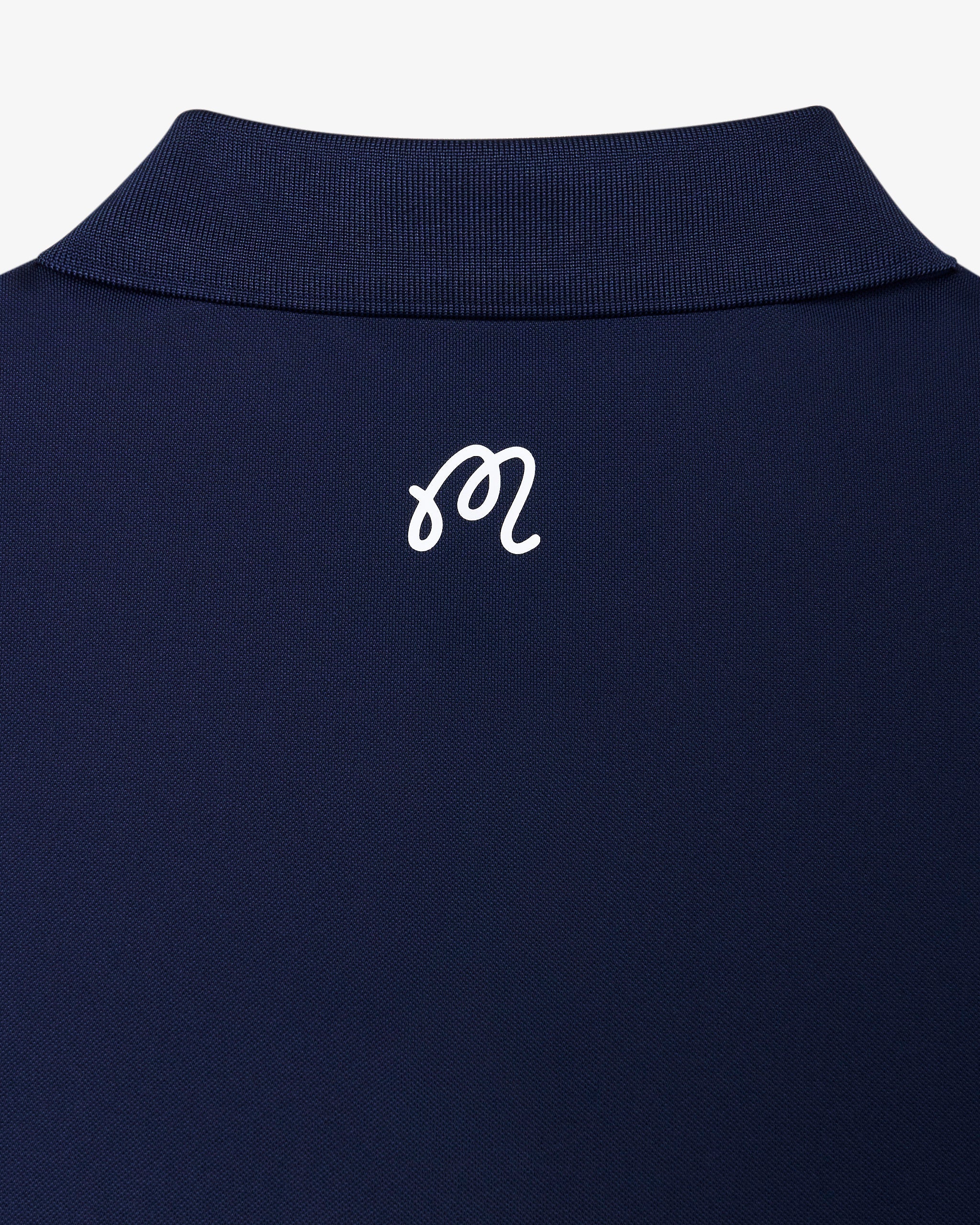Malbon Golf Block Placket Polo Navy – back view showing the M script logo