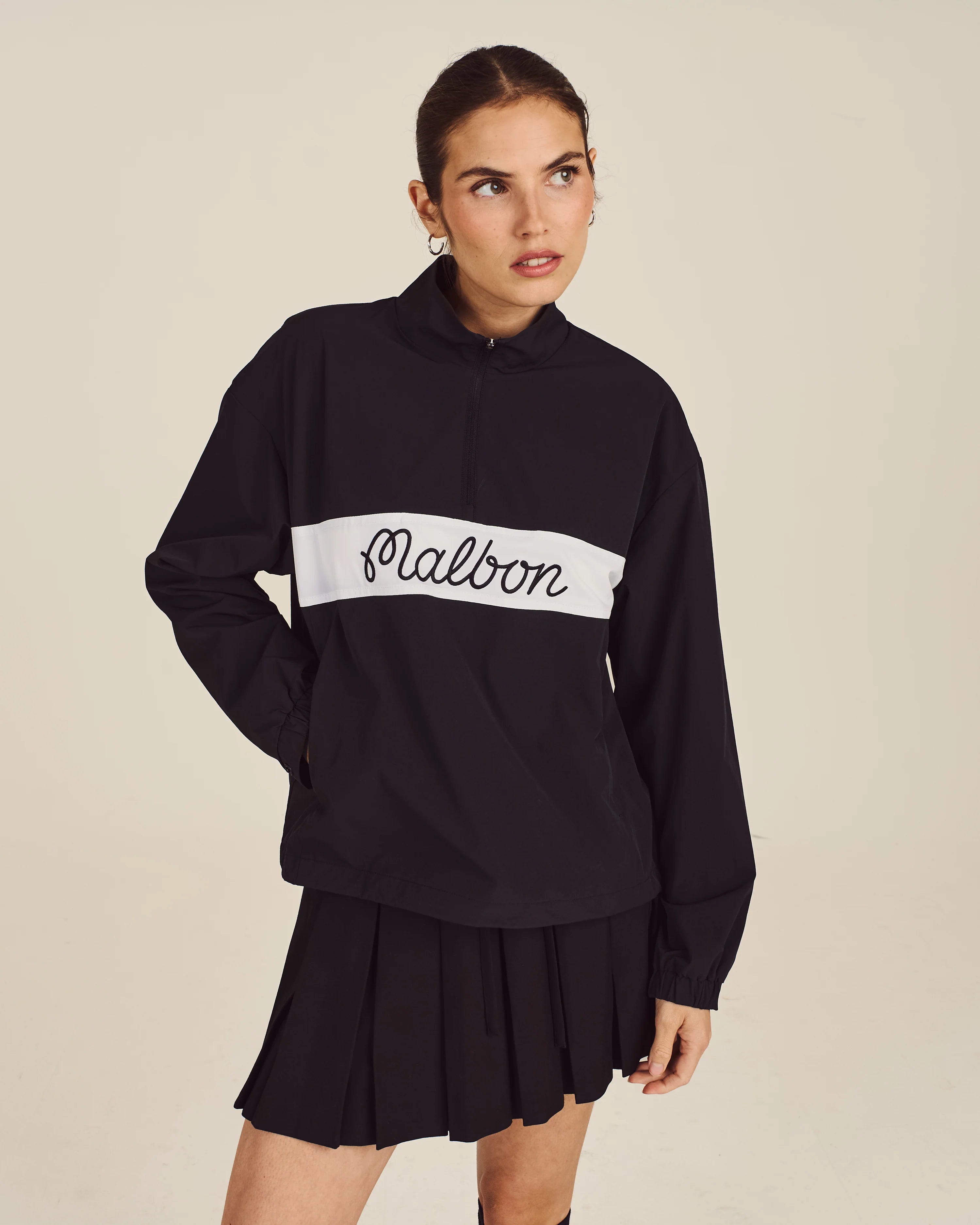 Malbon Golf Giselle Skirt in Black worn on course — women's golf apparel