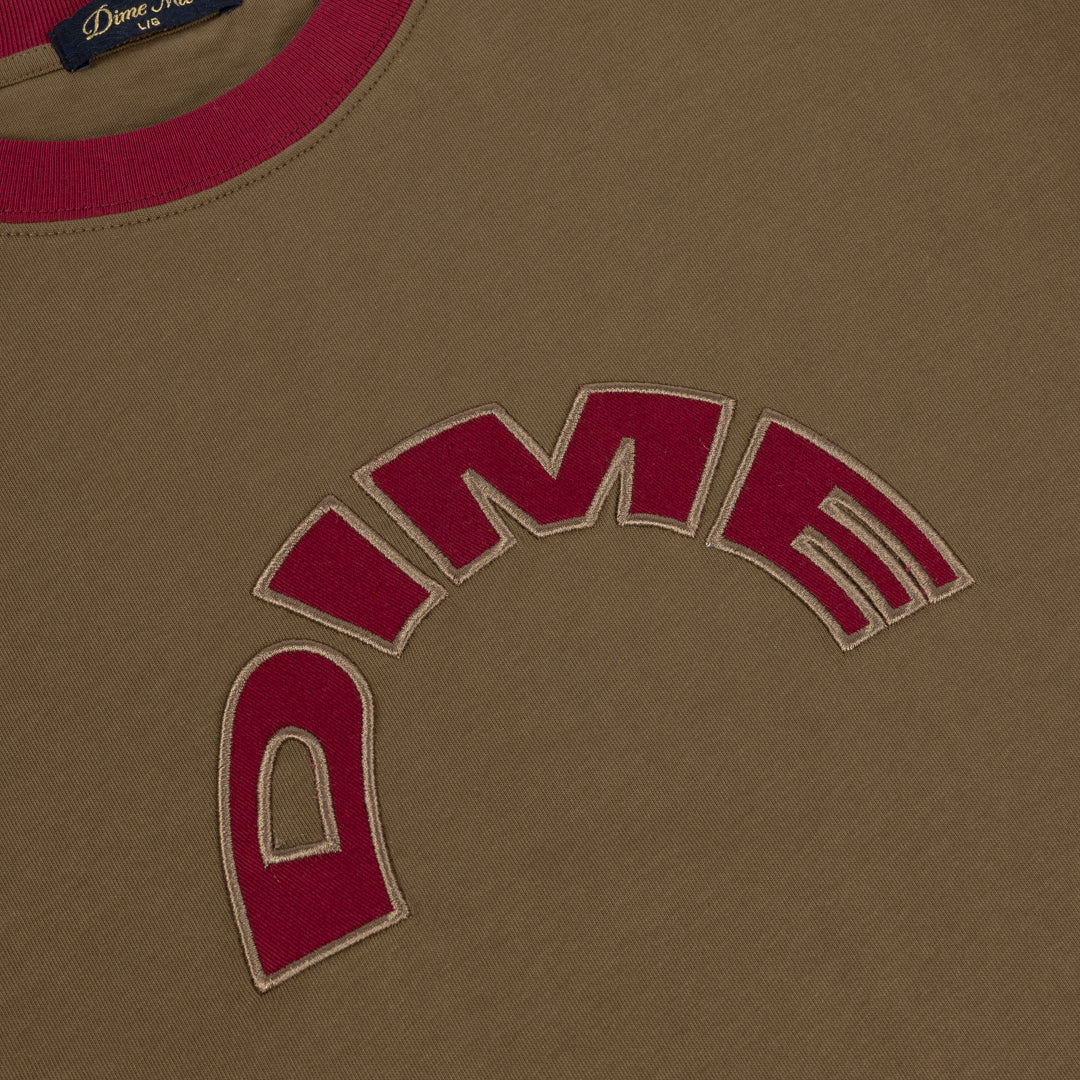 Close-up of the red arched DIME appliqué on the Brown Arch Ringer T-Shirt