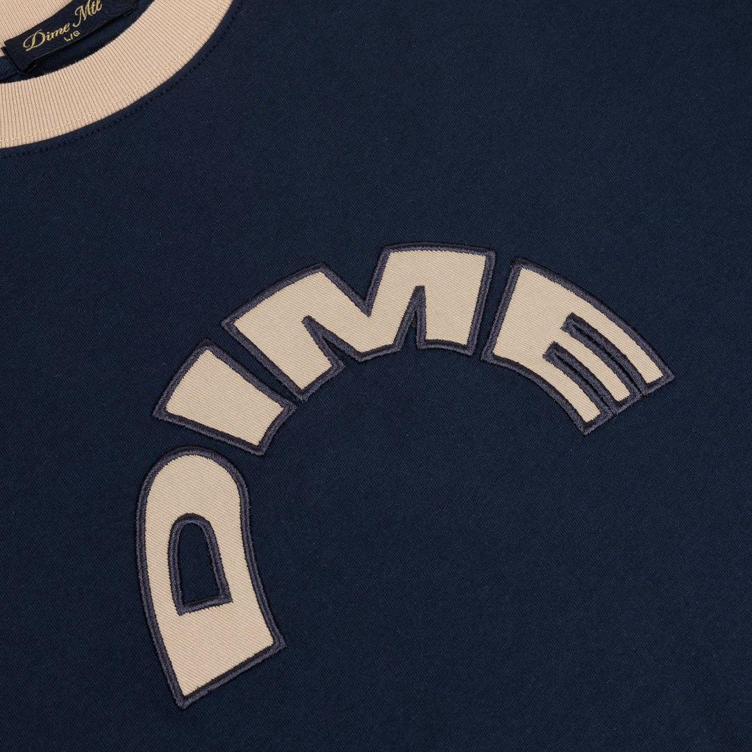 Close-up of the arched DIME appliqué on the Navy Arch Ringer T-Shirt