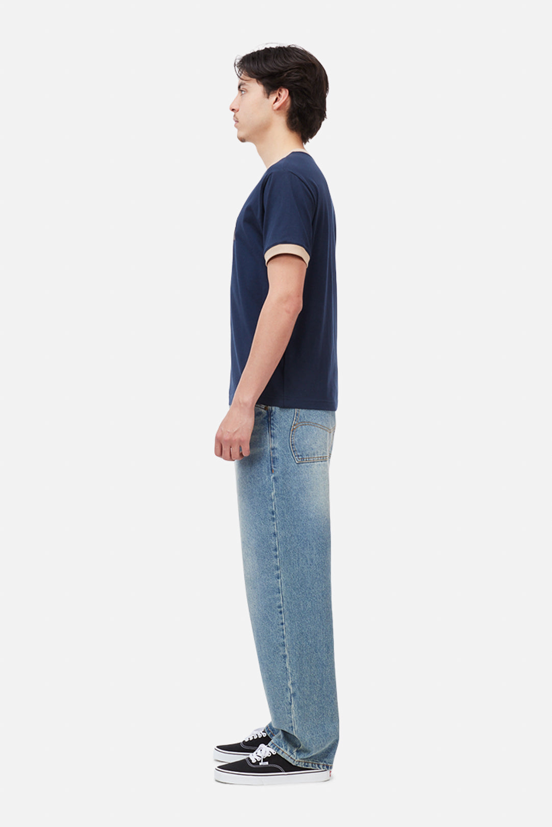 Model wearing the Dime MTL Arch Ringer T-Shirt in Navy, side view