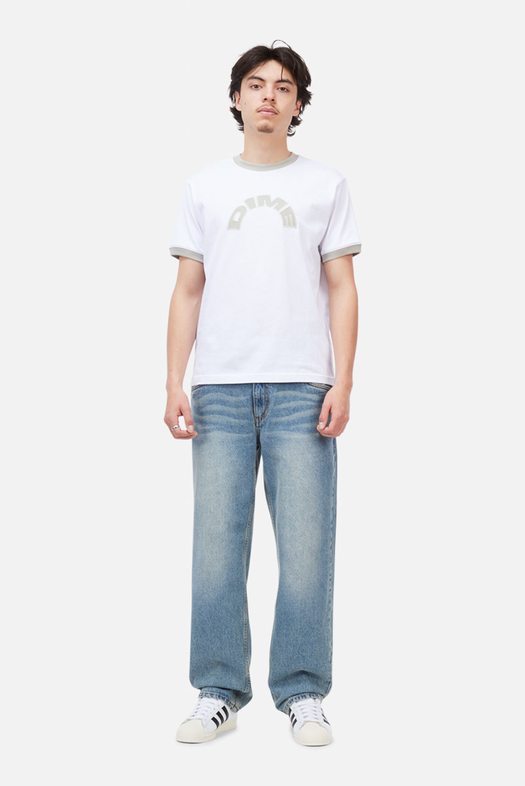 Model wearing the Dime MTL Arch Ringer T-Shirt in White, front view