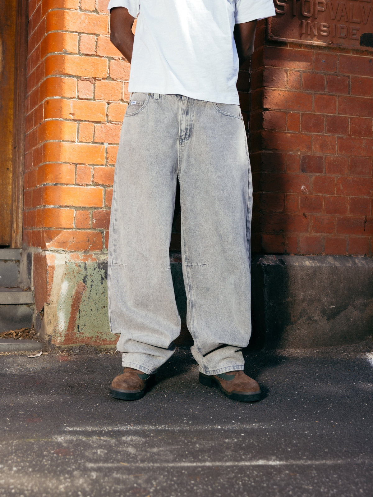 Butter Goods Wide Cut Denim Jeans Grey Wash — worn by model