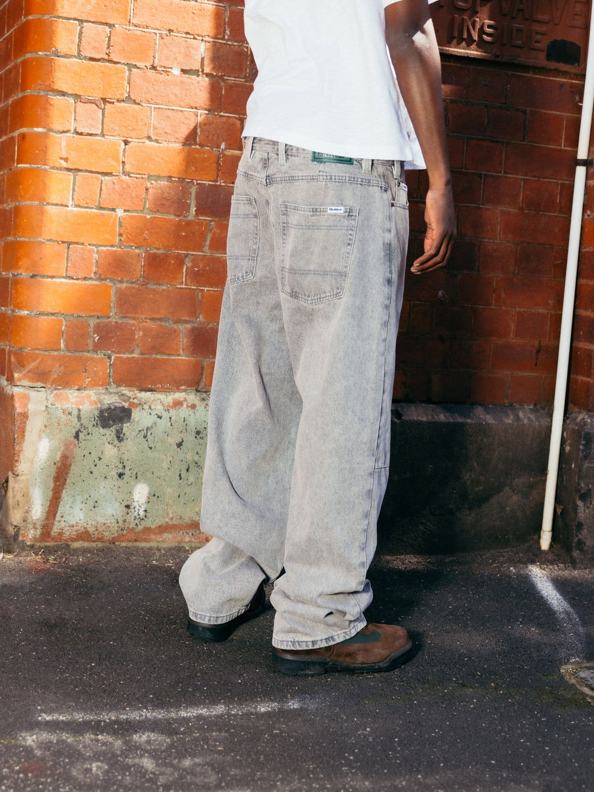 Butter Goods Wide Cut Denim Jeans Grey Wash — worn by model