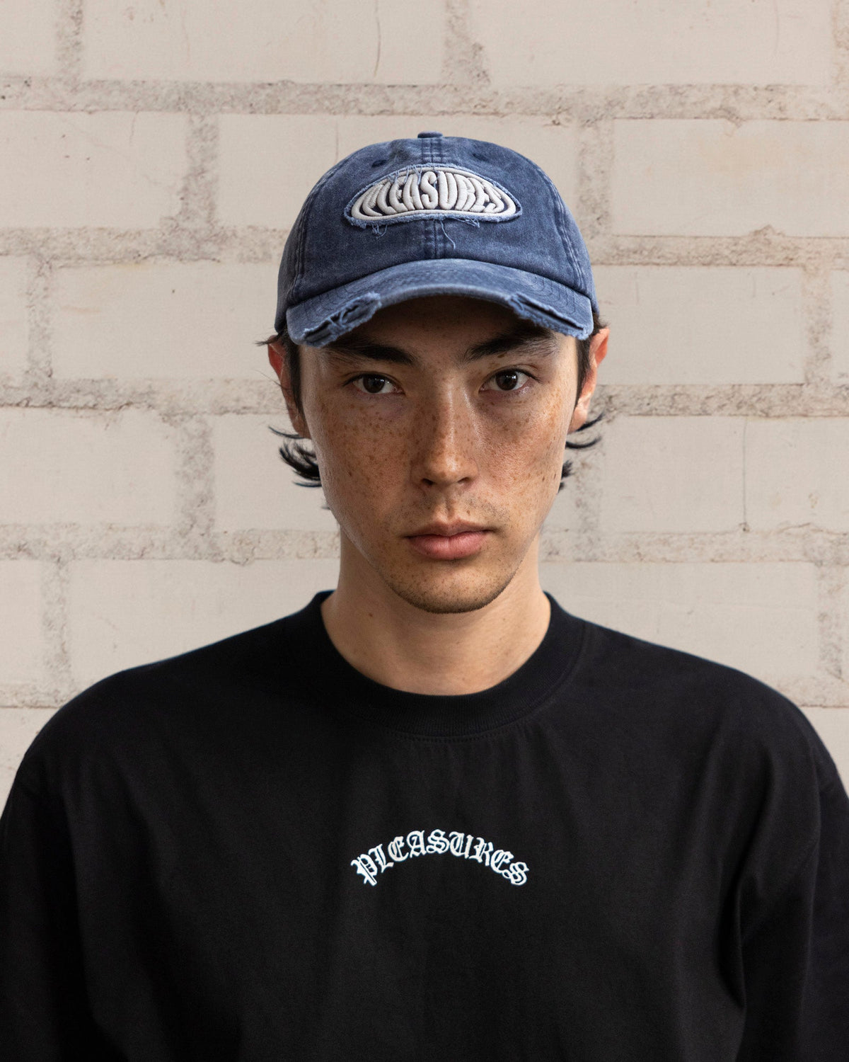 Pleasures Bubble Rip Cap Navy — navy cotton cap worn on model, Gallery Streetwear Canada