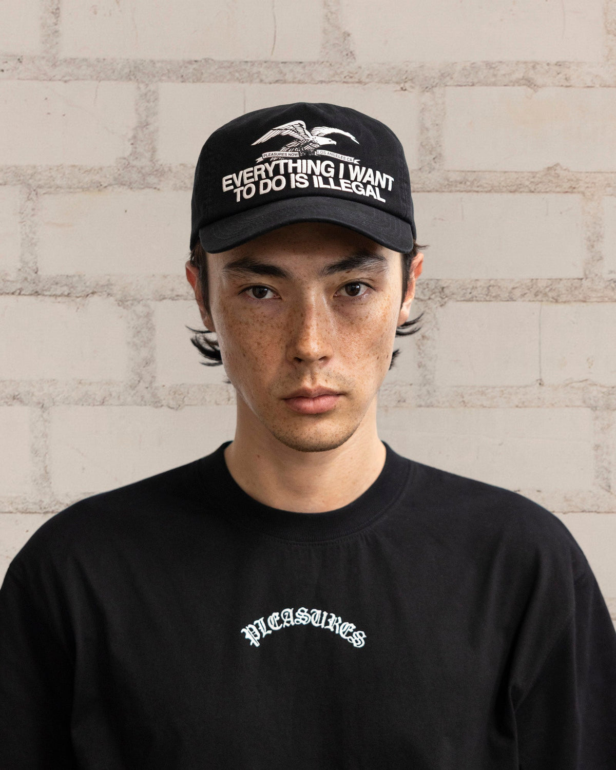 Pleasures Illegal Snapback Black — black cotton snapback cap worn on model, Gallery Streetwear Canada