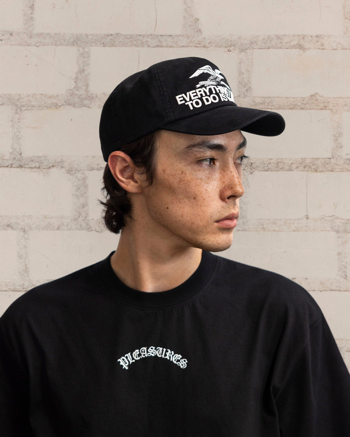 Pleasures Illegal Snapback Black — black cotton snapback cap worn on model, Gallery Streetwear Canada