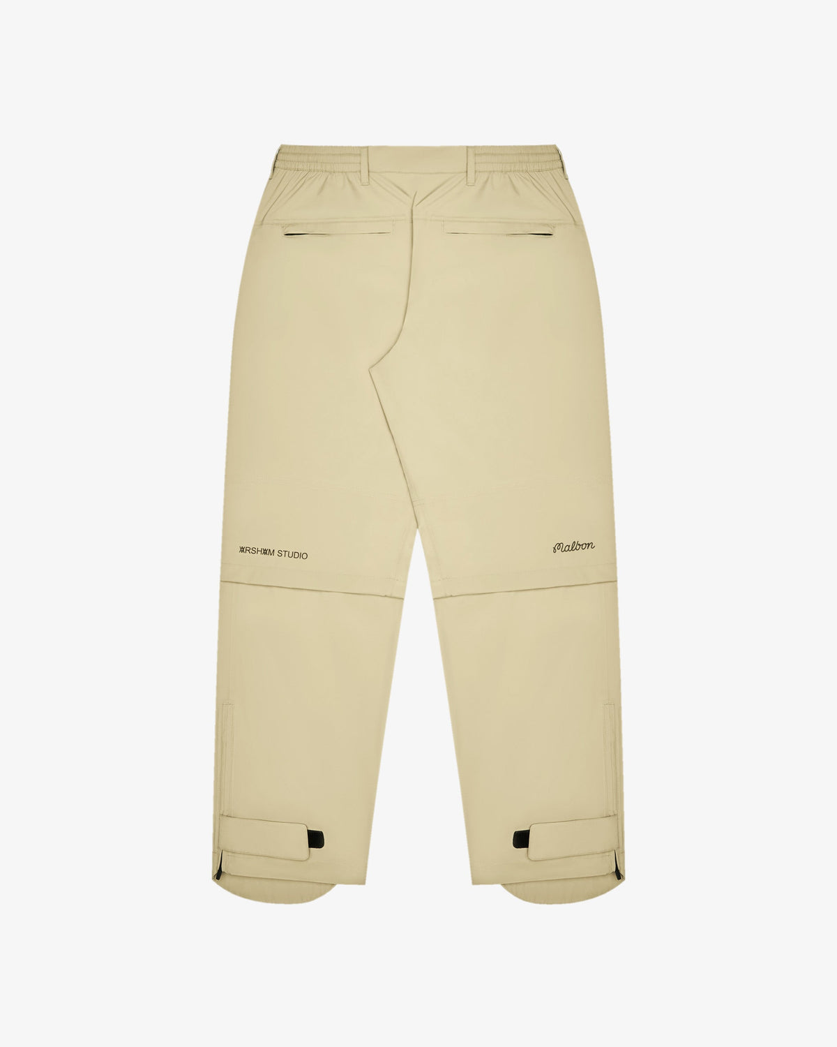 Malbon Golf x Daniel Arsham Flint Stealth Rain Pant – Dune — product view, beige rain pant with convertible zip-off knee detail, Gallery Streetwear Canada