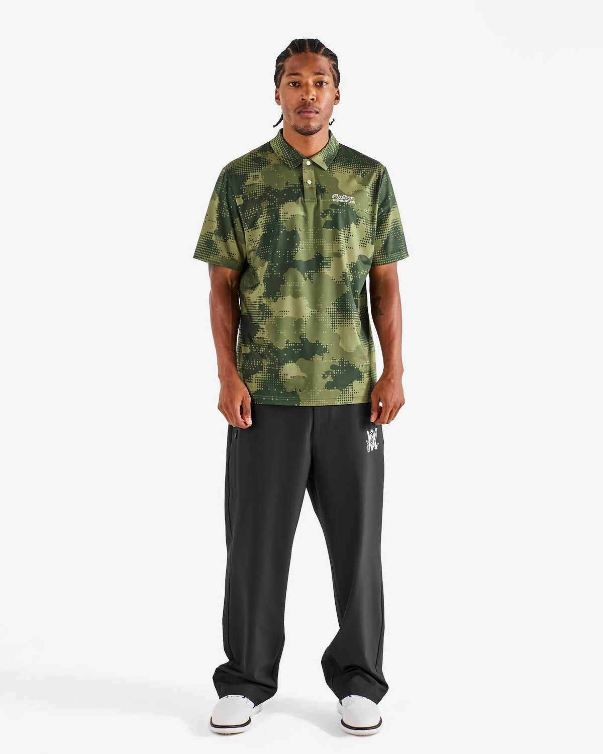 Malbon Golf x Daniel Arsham Fairway Stealth Polo – Olive Stealth Camo worn on model — olive dotted-camo golf polo, Gallery Streetwear Canada