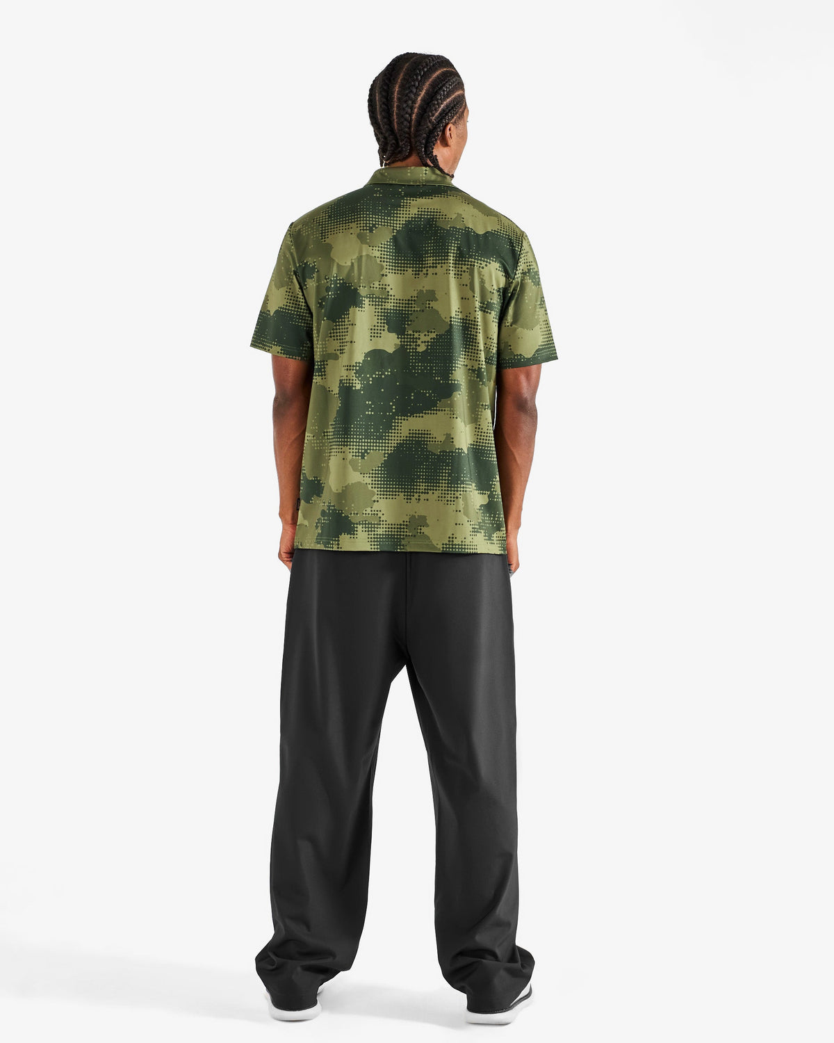 Malbon Golf x Daniel Arsham Fairway Stealth Polo – Olive Stealth Camo worn on model — olive dotted-camo golf polo, Gallery Streetwear Canada