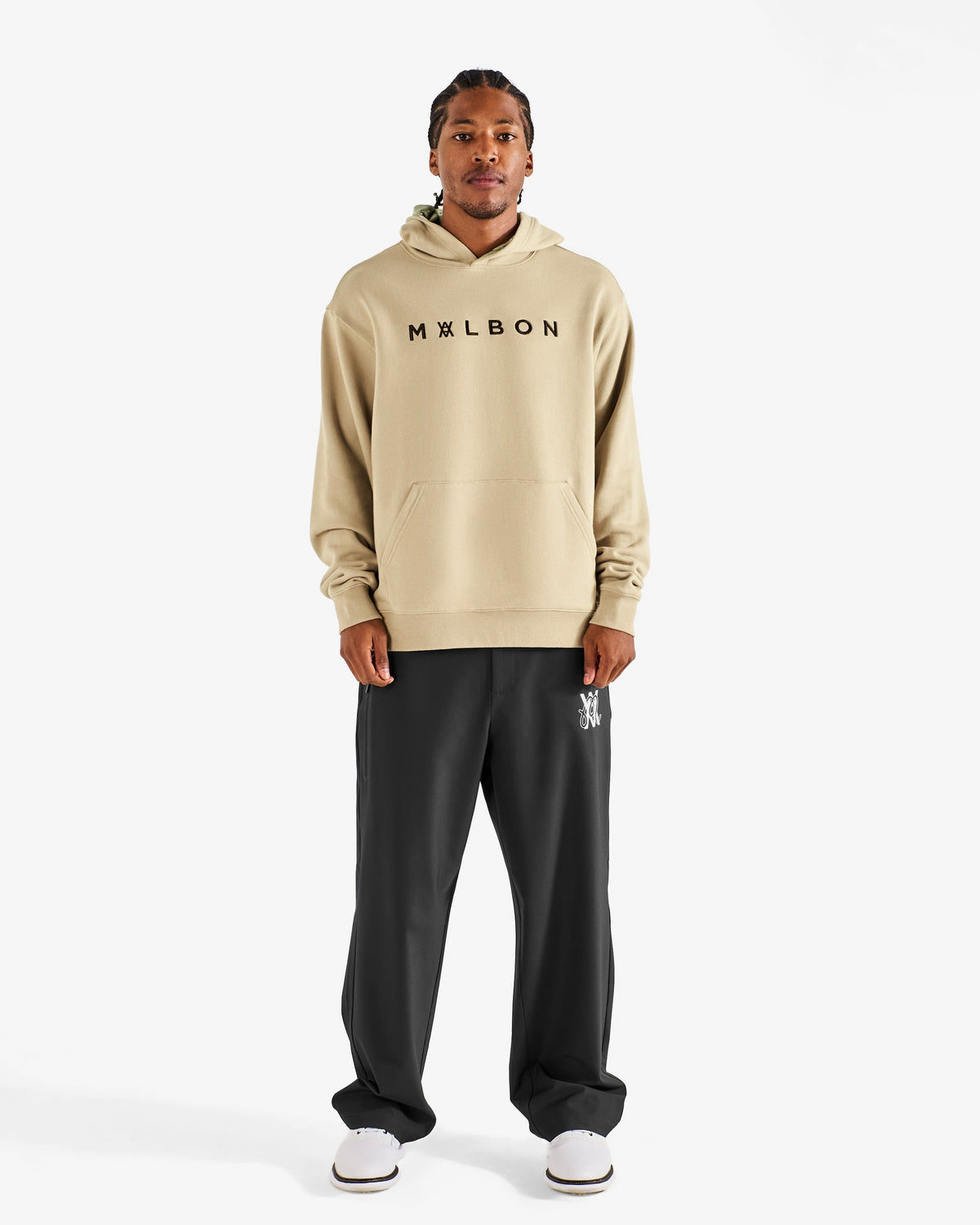 Malbon Golf x Daniel Arsham Shards Hoodie – Dune worn on model — beige pullover hoodie with Arsham shards graphic, Gallery Streetwear Canada