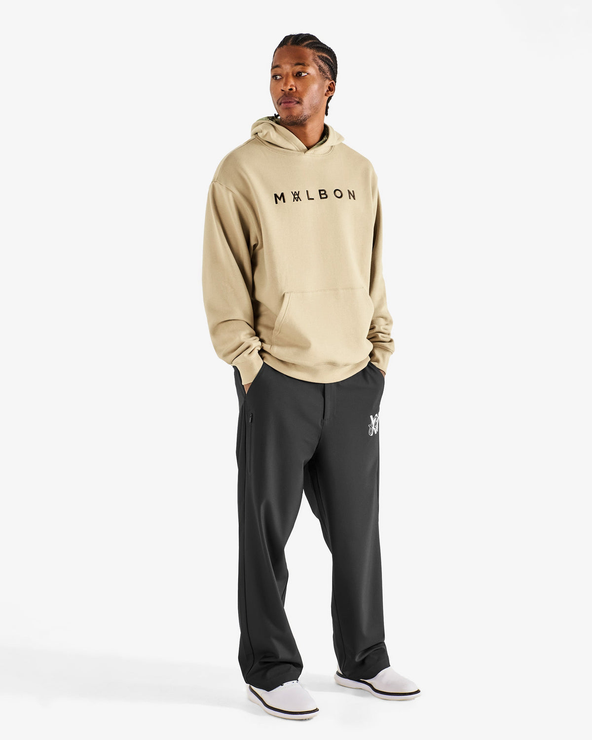 Malbon Golf x Daniel Arsham Shards Hoodie – Dune worn on model — beige pullover hoodie with Arsham shards graphic, Gallery Streetwear Canada