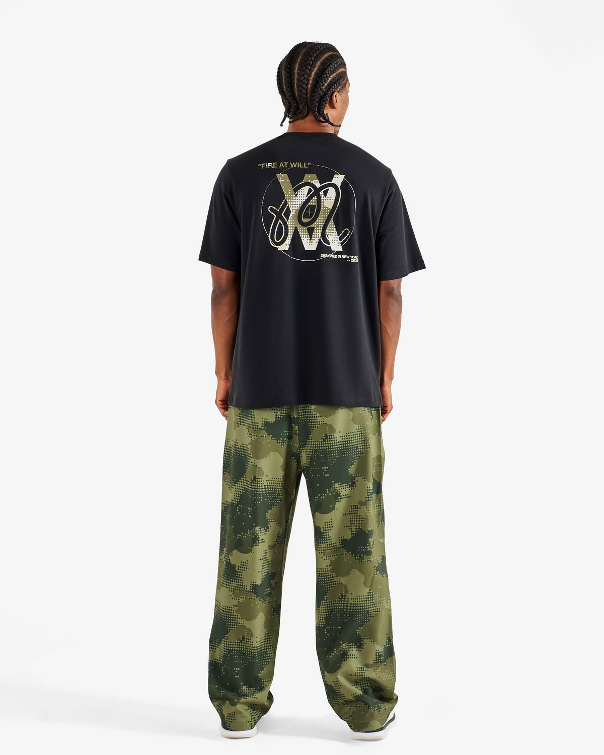 Malbon Golf x Daniel Arsham Bermuda Glyph Tee – Black worn on model — black cotton tee with Arsham glyph graphic, Gallery Streetwear Canada