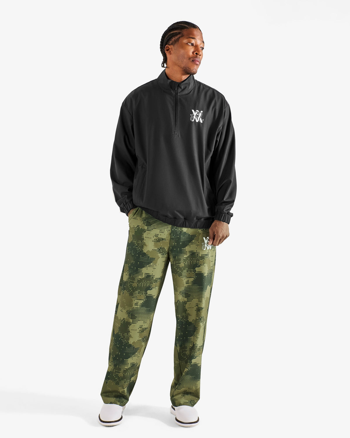 Malbon Golf x Daniel Arsham Stealth Quarter Zip – Black worn on model — black quarter-zip golf midlayer, Gallery Streetwear Canada