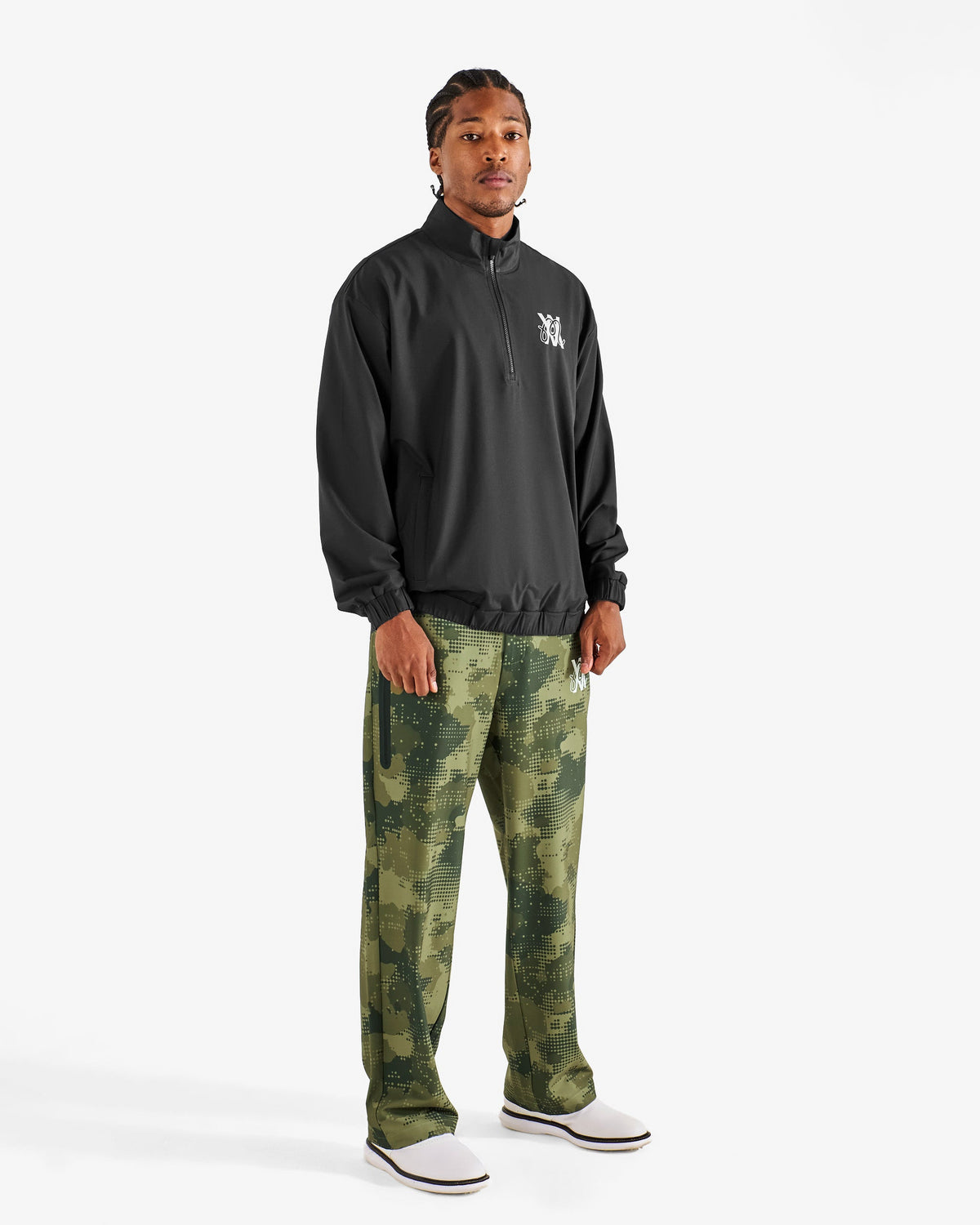Malbon Golf x Daniel Arsham Stealth Quarter Zip – Black worn on model — black quarter-zip golf midlayer, Gallery Streetwear Canada
