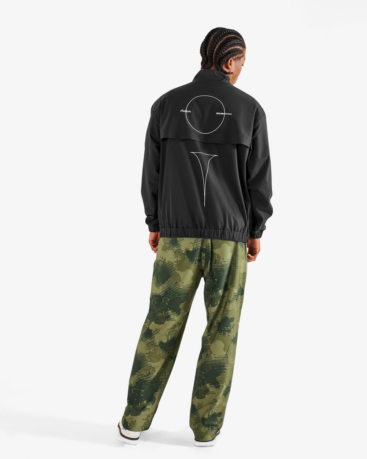 Malbon Golf x Daniel Arsham Stealth Quarter Zip – Black worn on model — black quarter-zip golf midlayer, Gallery Streetwear Canada